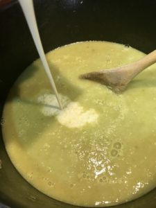 adding heavy cream to asparagus soup