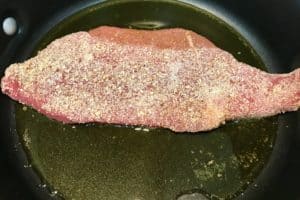 Frying meat for silpancho dish