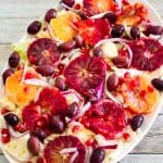 A salad platter with cabbage, blood orange, pomegranates, olives etc.