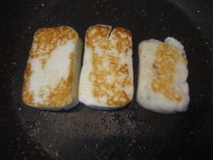 Frying halloumi on both sides until golden brown