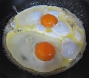 Frying the eggs sunny side up