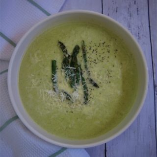 Low carb, keto friendly soup - cream of asparagus soup topped with roasted asparagus tips