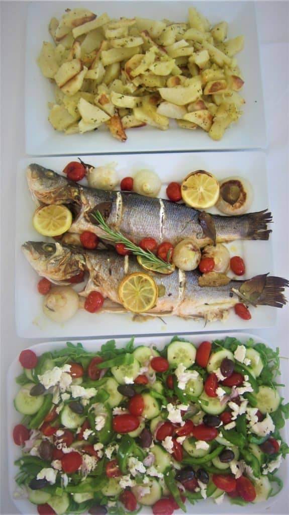 Baked Mediterranean Branzino or Sea-Bass served with an arugula/greek salad and roasted potatoes
