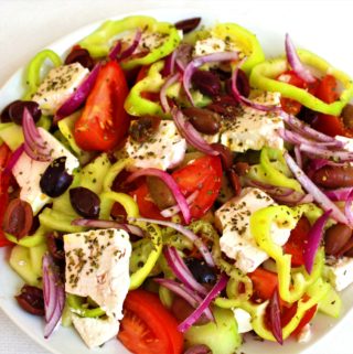 Greek Salad with tomatoes, cucumbers, feta cheese, olives, red onion