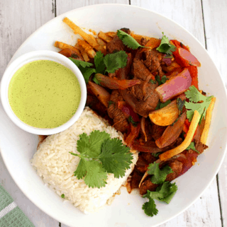 Peruvian Lomo Saltado - Beef Stir Fry Served with Salsa Verde, Rice and French Fries