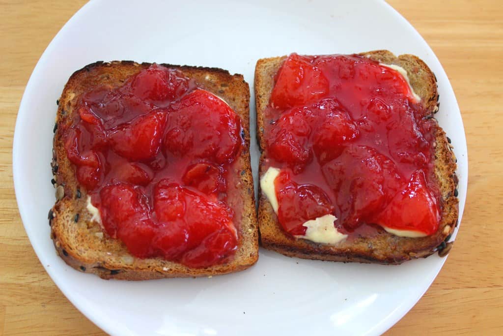 Toasted bread with butter and homemade red plum jam.