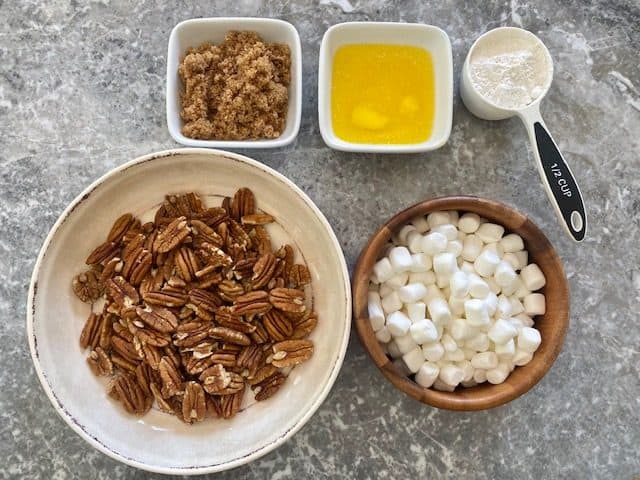 Ingredients for topping are layed out, pecans, marshmallows, butter, brown sugar and flour.