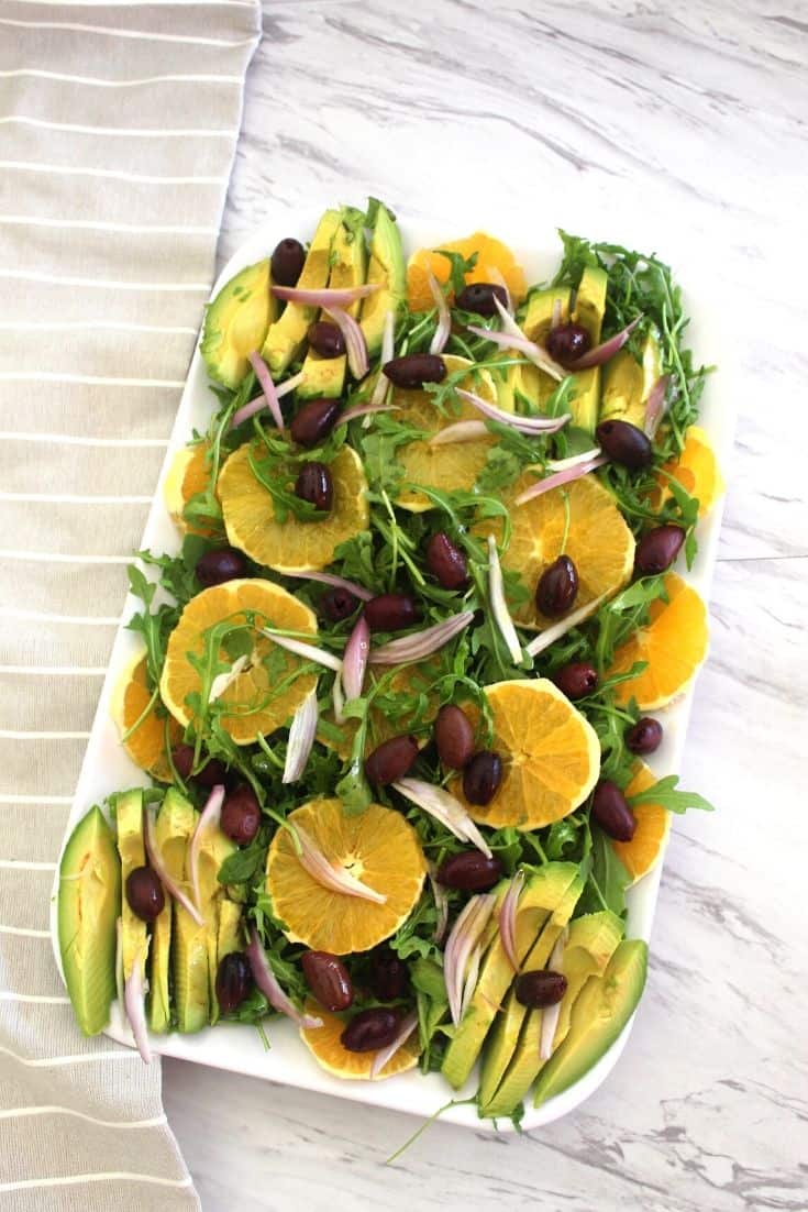 Delicious winter salad made with navel oranges, arugula, kalamata olives, red onions and avocados served with a citrus dressing.