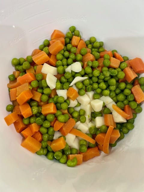 Diced potatoes, carrots and green peas in the salad bowl.