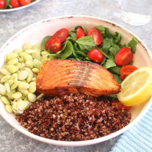 Healthy Salmon Red Quinoa Dinner Bowl with green lima beans, spinach and grape tomatoes.