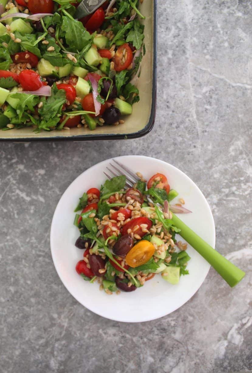 Healthy Mediterranean Farro Salad - picture shows a serving of the farro salad next to the salad bowl.