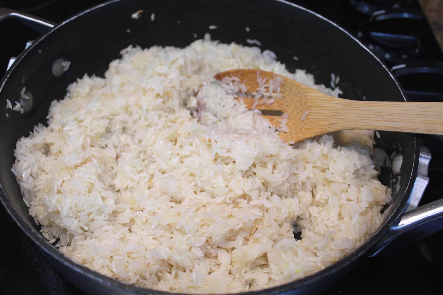 Saute rice in the same skillet where you were sauteing onions and garlic.
