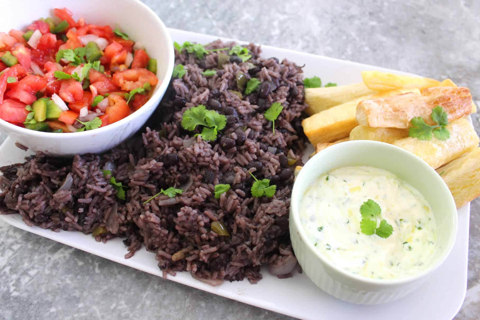 Family style rice and black beans dinner, shown with 2 side dishes.