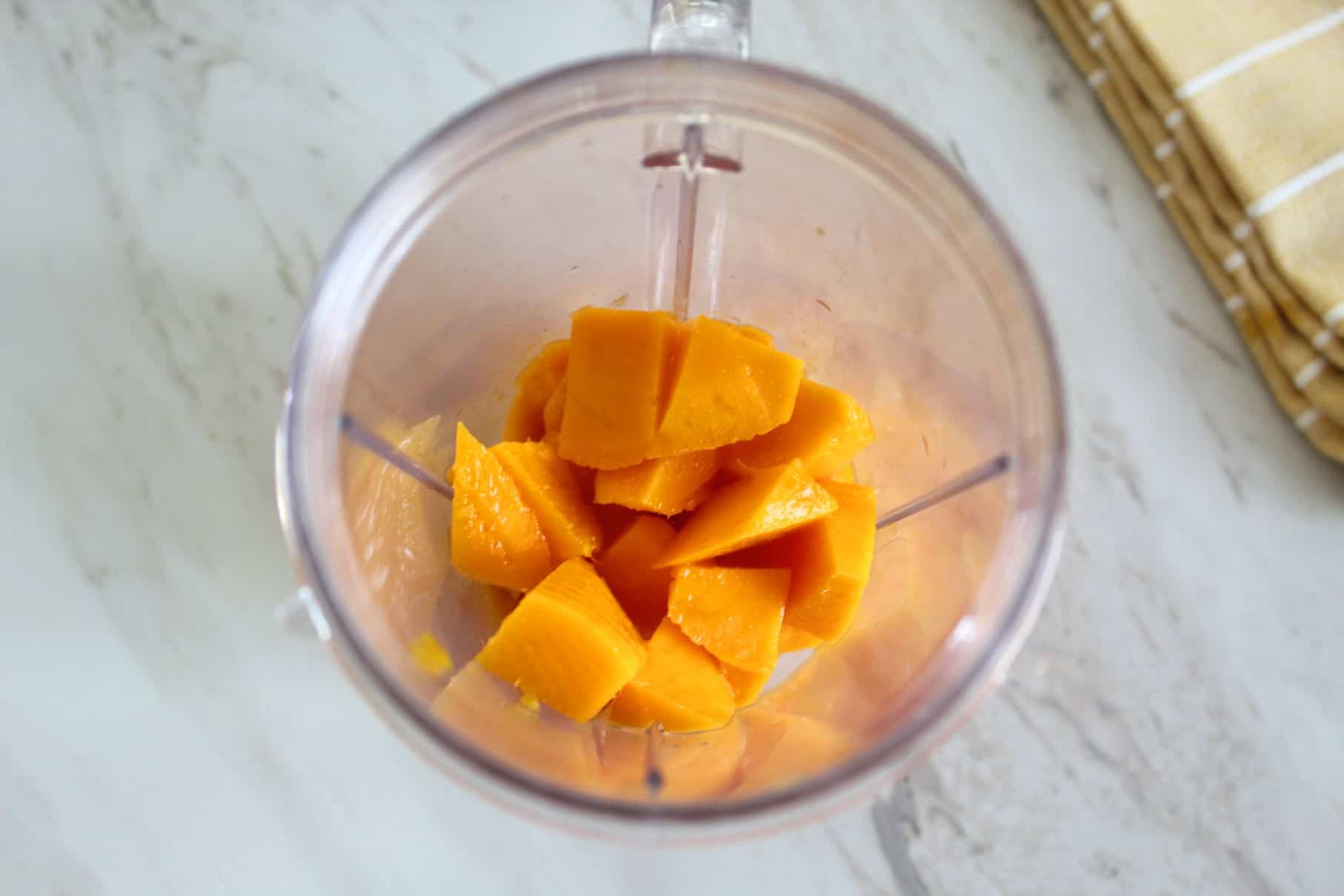 Chopped fresh mango into a blender