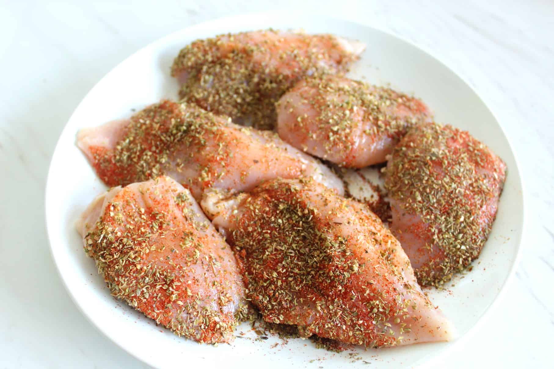 Seasoned chicken breasts (6 pieces) uncooked.