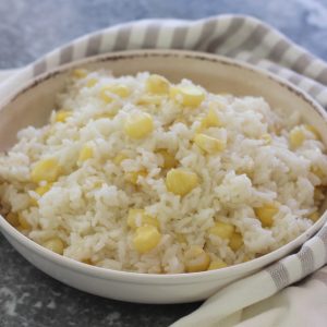 A wide dish with rice called Arroz con Choclo in Spanish. This rice is cooked with a special corn from the Andean region in South America.