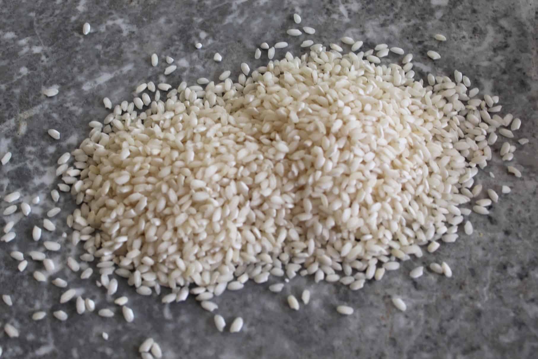 Arborio rice grains spread out on a counter