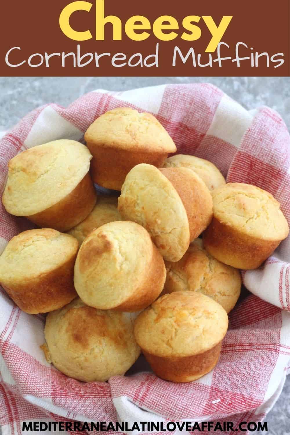 Cornbread muffins in a basket lined up with a kitchen towel. Image is prepared for Pinterest with a title bar over the image and the website link listed below. 