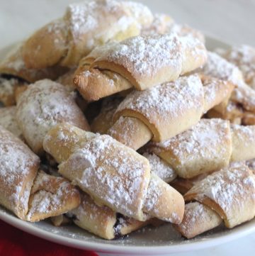 Soft jam filled cookies in crescent shape. They're covered in confectioner's sugar.