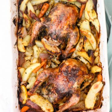 Roasted chicken and potatoes in a baking dish