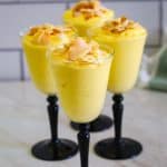 Served Mango Mousse on long liquor cups. Mousse is topped with coconut chips. Picture shows 4 cups.