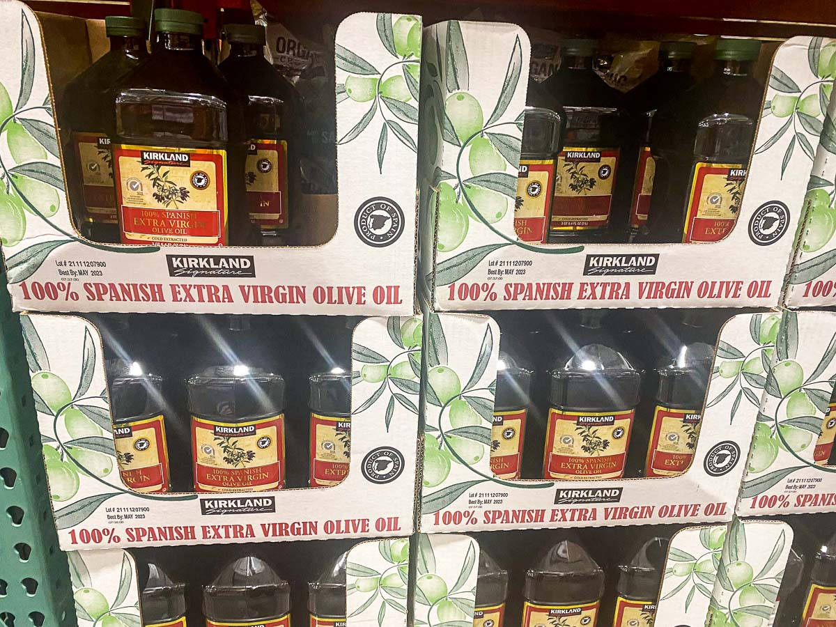 Olive oil in boxes in Costco store. Boxes read 100% Spanish Extra Virgin Olive Oil.