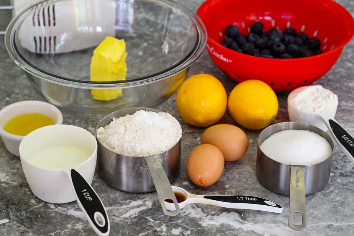Ingredients all together before making batter: butter, blueberries, meyer lemons, flour, sugar, eggs, vanilla extract. 