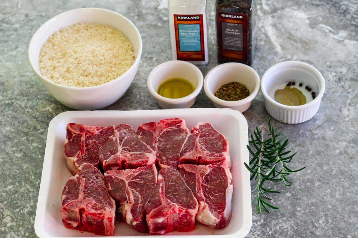 Ingredients need to cook the lamb/rice baked casserole: lamb chops, rice, olive oil, rosemary, oregano, garlic, salt, pepper, bay leaves, peppercorn. 