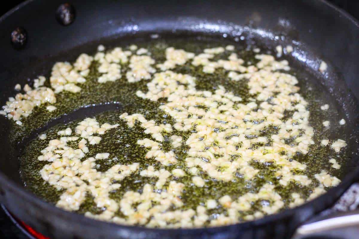 Sauteing garlic in olive oil.