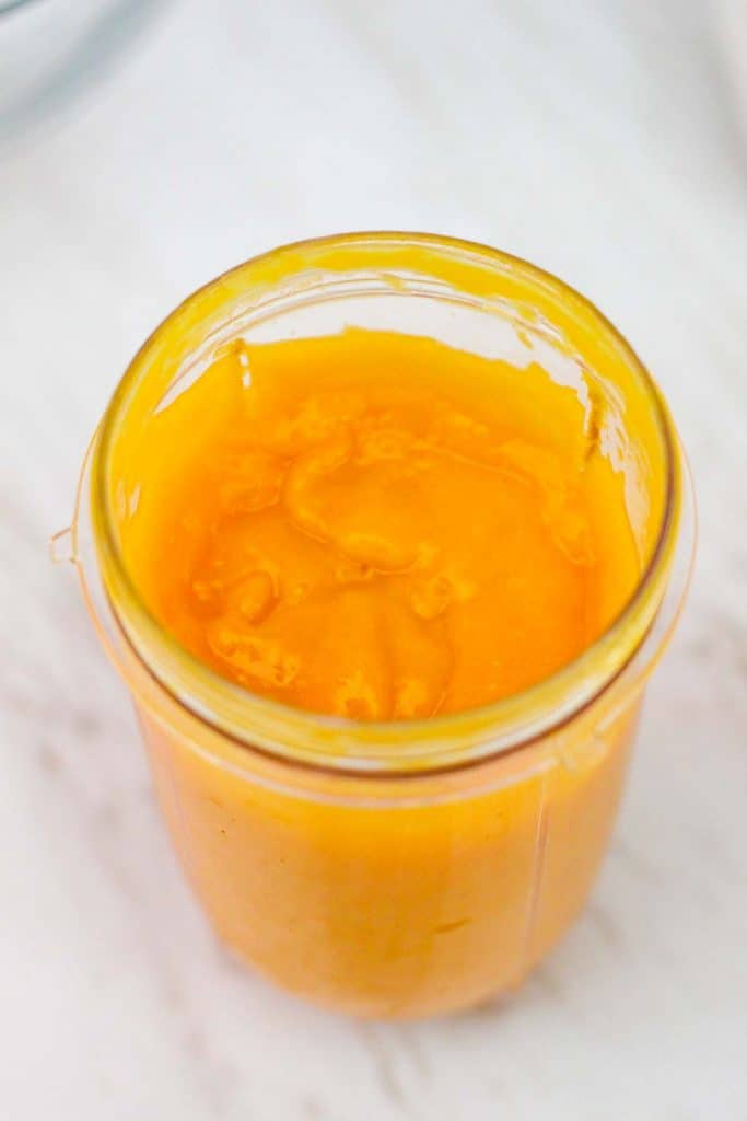 Blended mango on the blender cup. Mango looks creamy.
