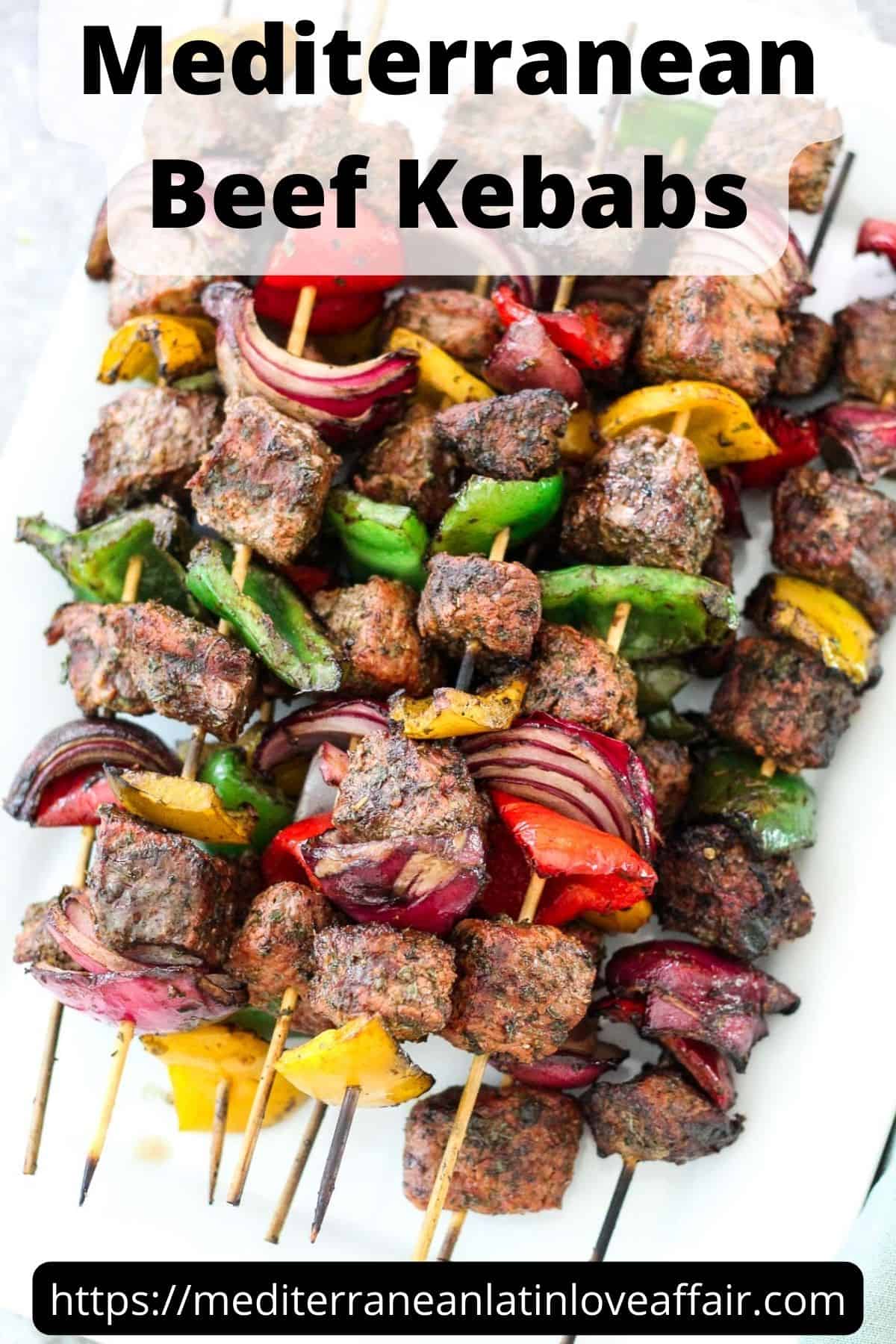An image prepared for Pinterest, it shows a picture of the Mediterranean beef kebabs. There's a title bar on top and the website link at the bottom.