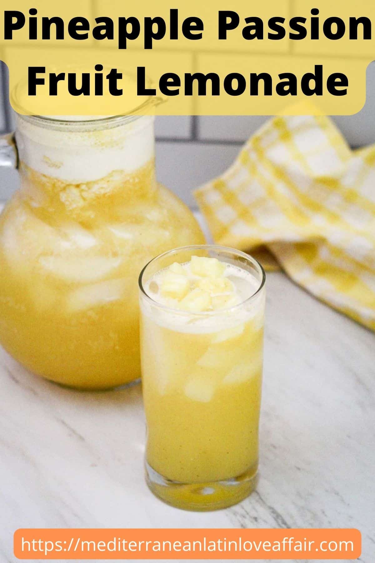 A yellow lemonade on a glass with ice and fresh fruit on top. There's a jug with same drink in the background. The picture has a title bar that reads Pineapple Passion Fruit Lemonade and at the bottom there's a website link where recipe first appeared. 