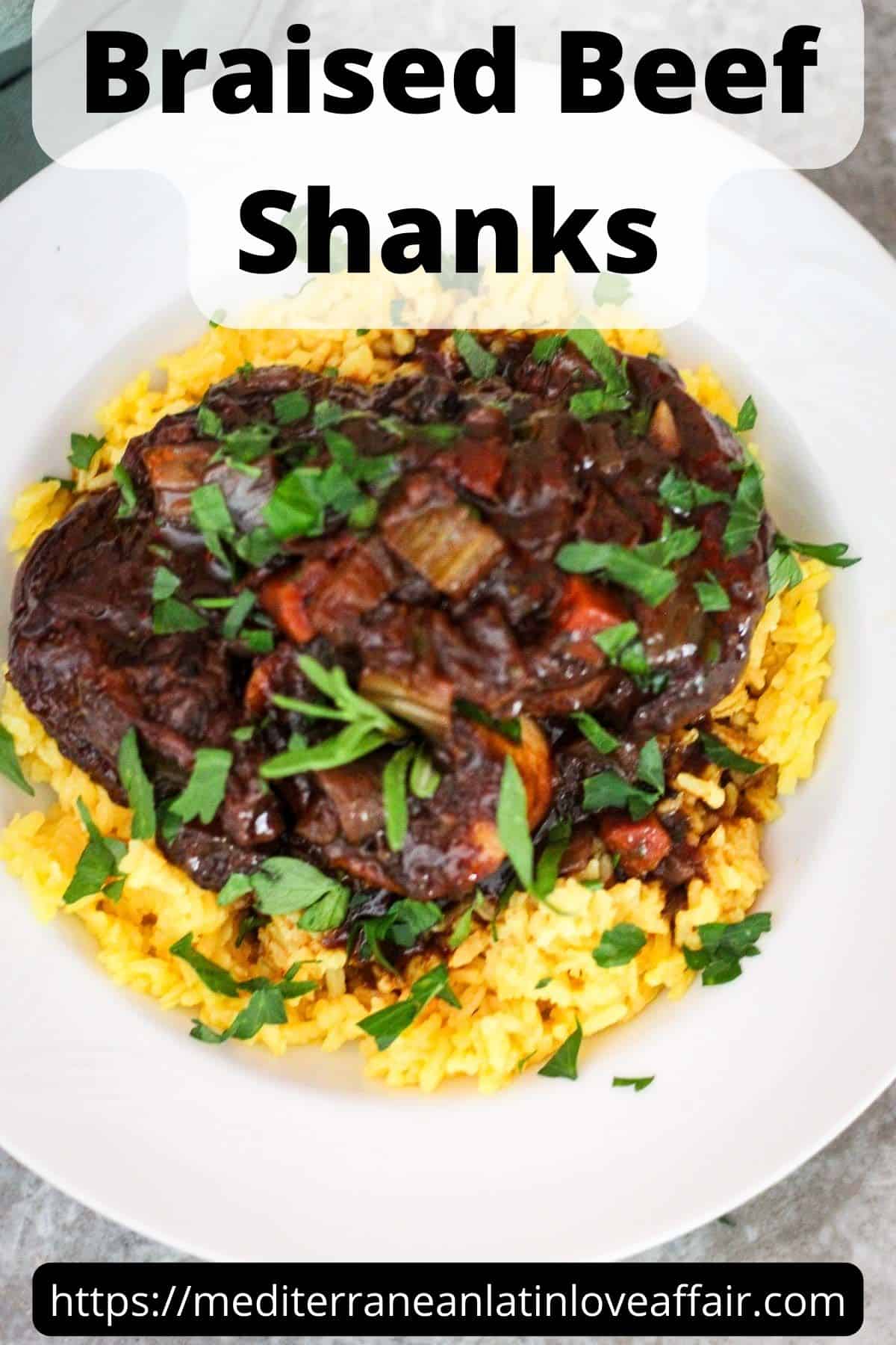 An image prepared for Pinterest. It shows a plate with yellow rice and beef shanks, garnished with greens. There's a title bar that reads Braised Beef Shanks and at the bottom there's the website link.