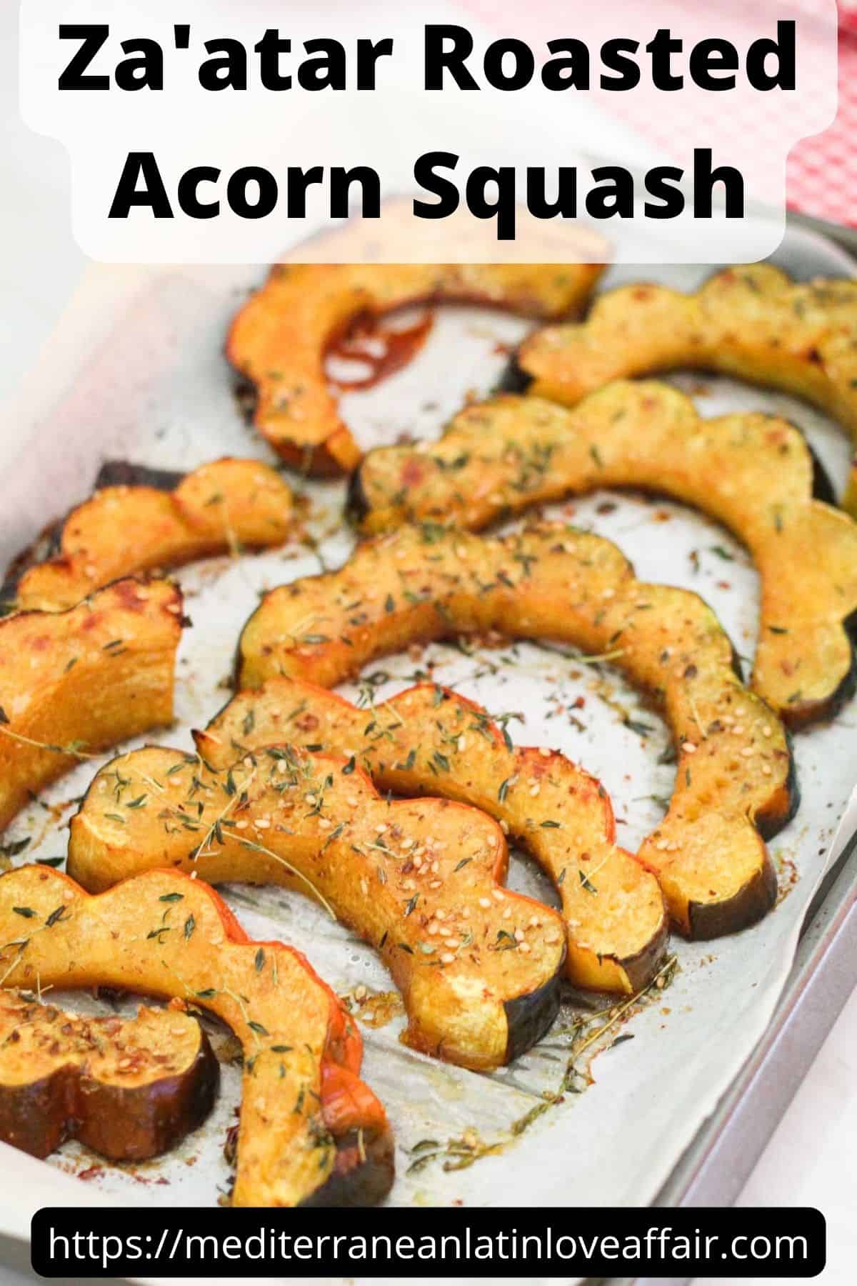 An image prepared for Pinterest. It shows roasted squash slices on a tray with lots of herbs. There's a title bar on top that reads Za'atar Roasted Acorn Squash and a website link on the bottom.
