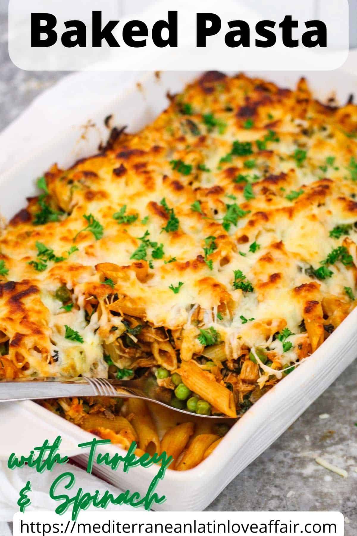 An image prepared for Pinterest, it shows a picture of a white casserole dish with baked pasta and a serving utensil. Pasta is garnished with fresh parsley.  There's a title bar on top of the picture and a website link bar at the bottom. 