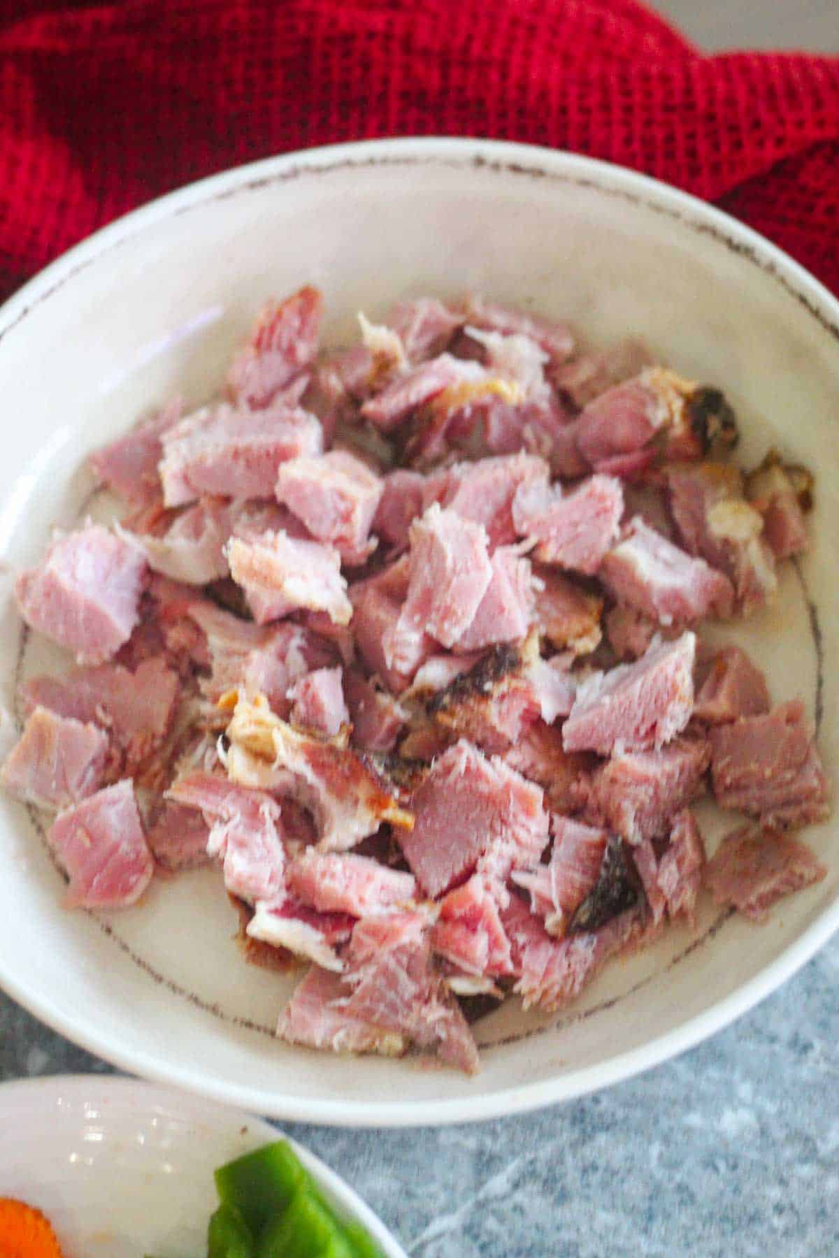 Diced ham for soup in a plate.