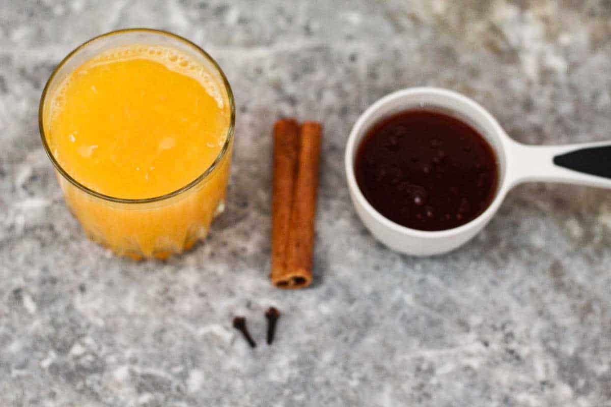 Ingredients for syrup (missing water in the picture) - orange juice, cinnamon stick, honey and cloves. 
