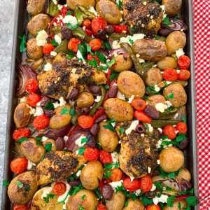 A sheet pan dinner with chicken and veggies. This dish is Mediterranean style with feta cheese and kalamata olives.