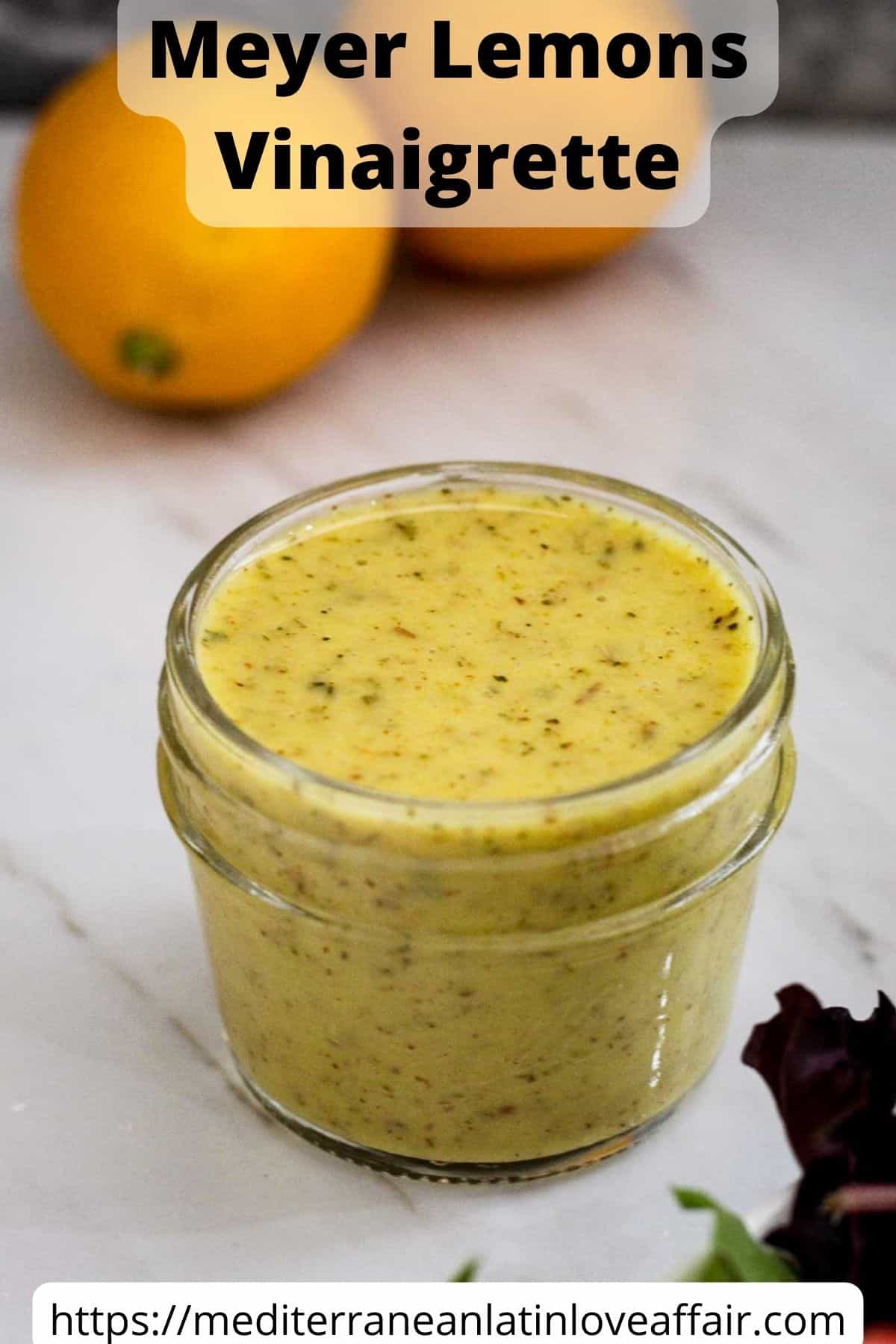 Best Meyer lemon vinaigrette - vinaigrette is in a small mason jar, ready to serve over a salad. There's a title bar over the picture and a website link at the bottom.
