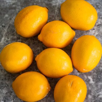 Meyer lemons on a counter.