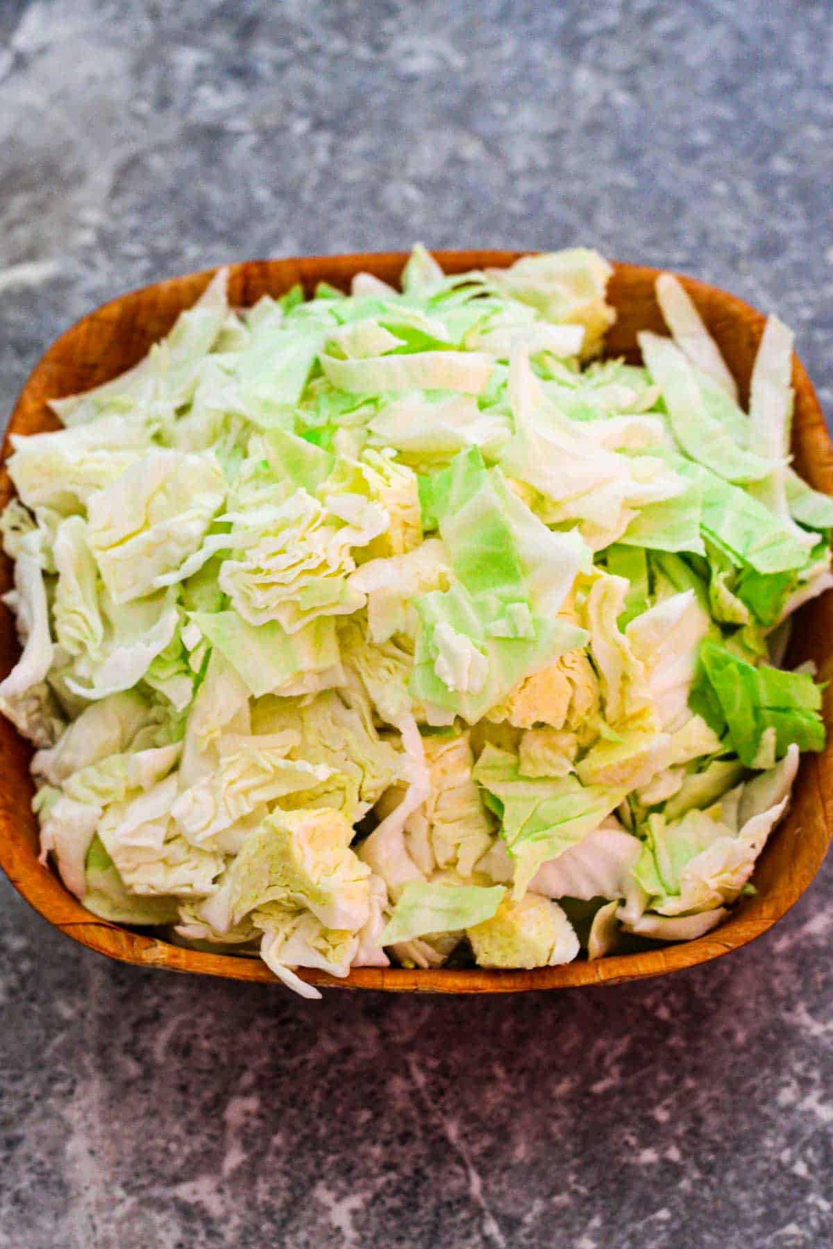 Roughly chopped cabbage in a square bowl.
