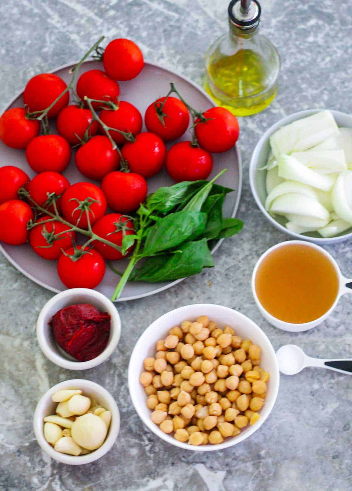 
Ingredients for roasted tomato soup: Campari tomatoes, onions, olive oil, garlic, chicken broth, tomato paste, chickpeas, salt (not all ingredients are pictured for example black pepper, thyme and heavy cream).
