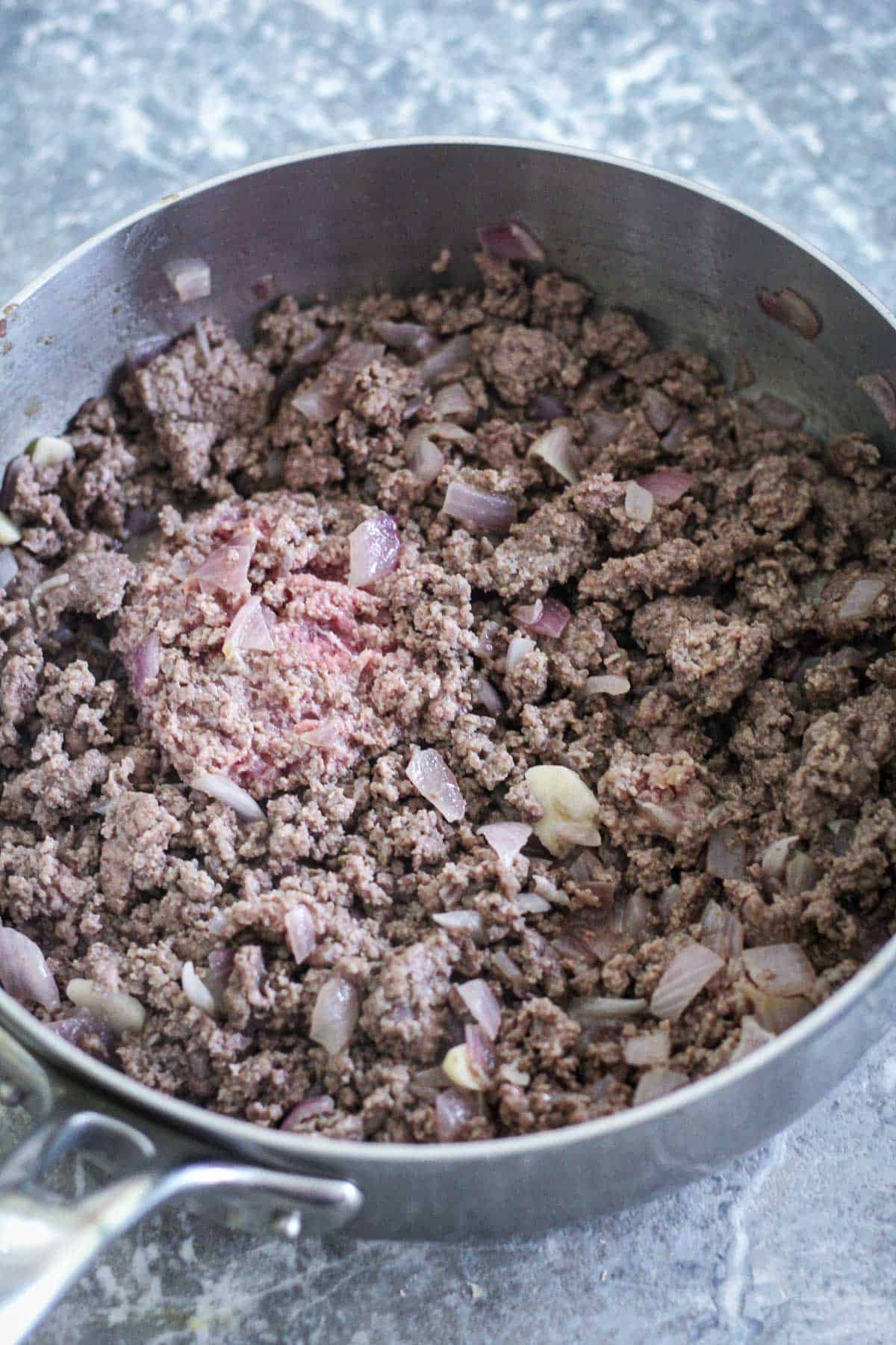 Browning ground beef.