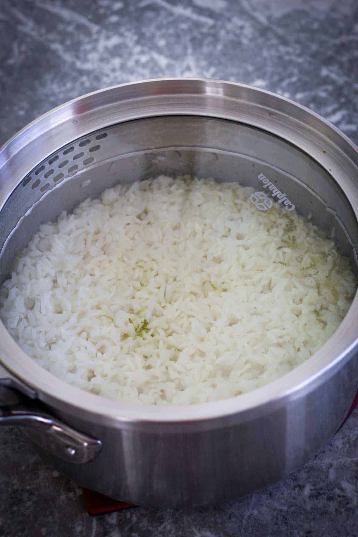 Cooking jasmine rice in a pot with a glass lid on. 