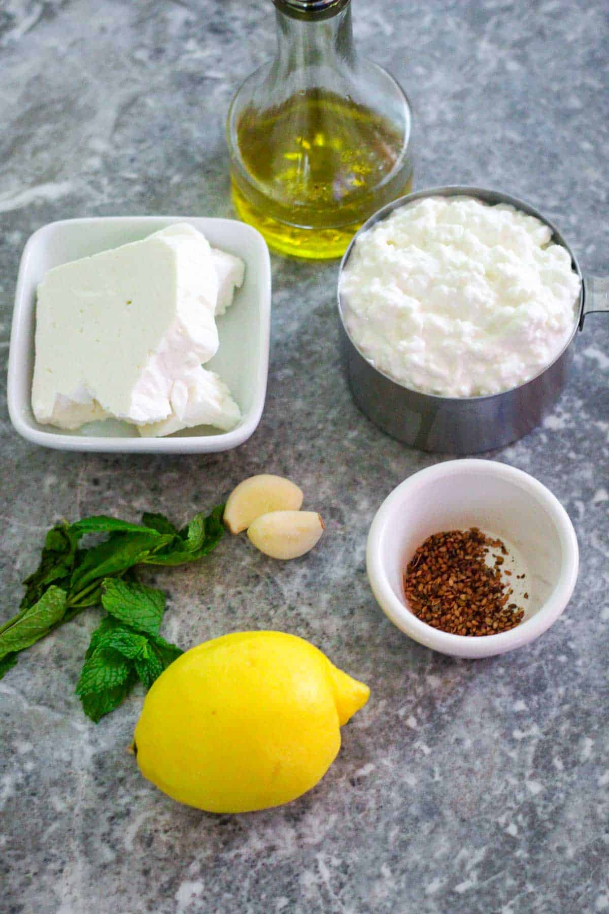 Ingredients for the cottage cheese dip: cottage cheese, feta cheese, olive oil, za'atar, lemon, garlic and mint. 