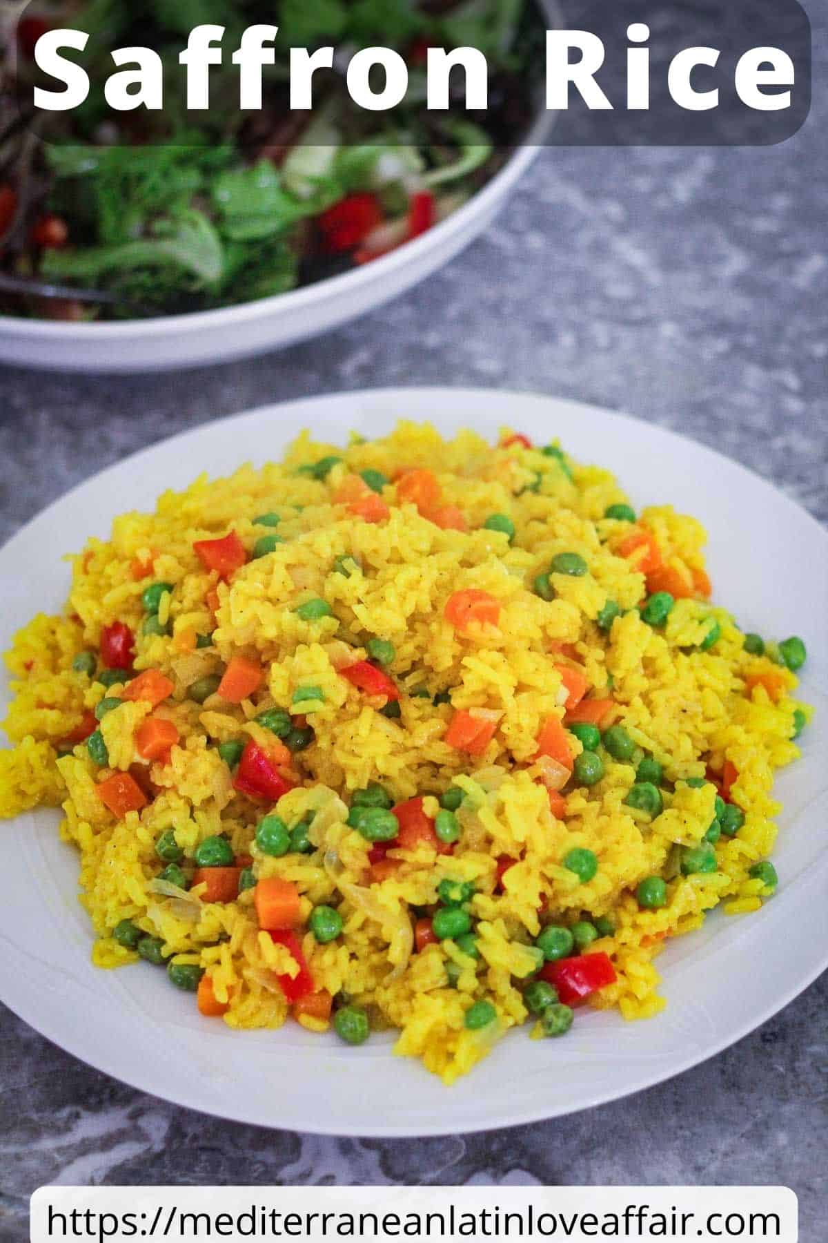 An image prepared for Pinterest. It shows a white round plate, full of saffron rice and veggies. There's a title bar on top and a website link at the bottom. In the background, you can see a plate of salad.