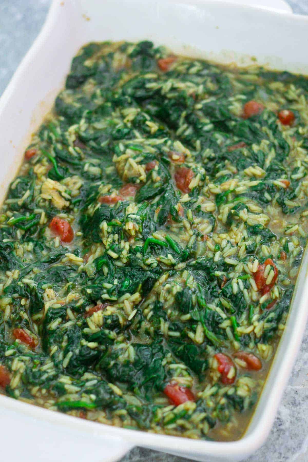 Spinach and rice on the baking dish, before baking. 