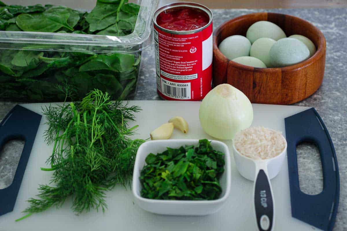 Main ingredients needed for Albanian burani: spinach, tomatoes, eggs, dill, parsley, onion, garlic, rice etc.