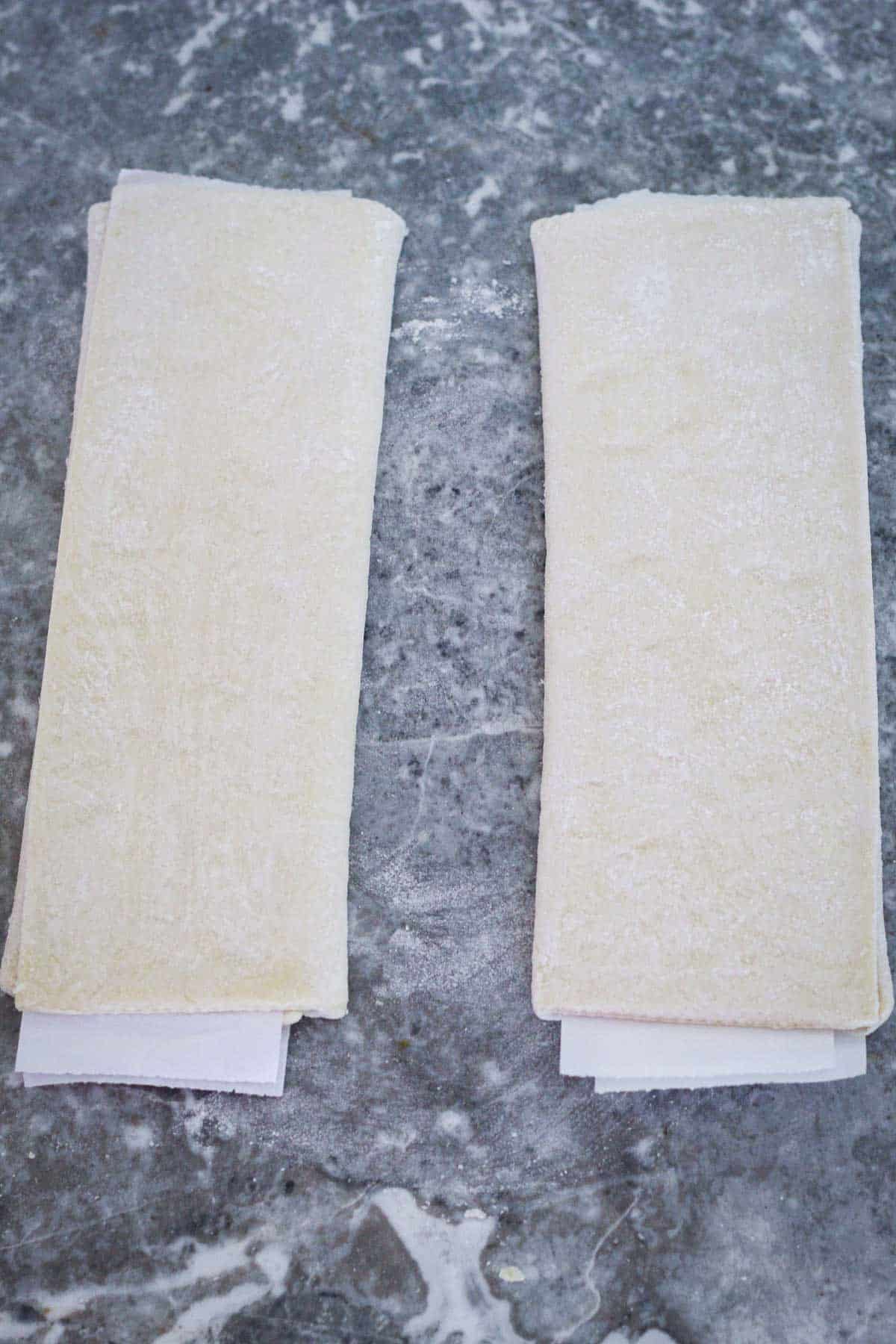 Two packs of puff pastry, unbaked.