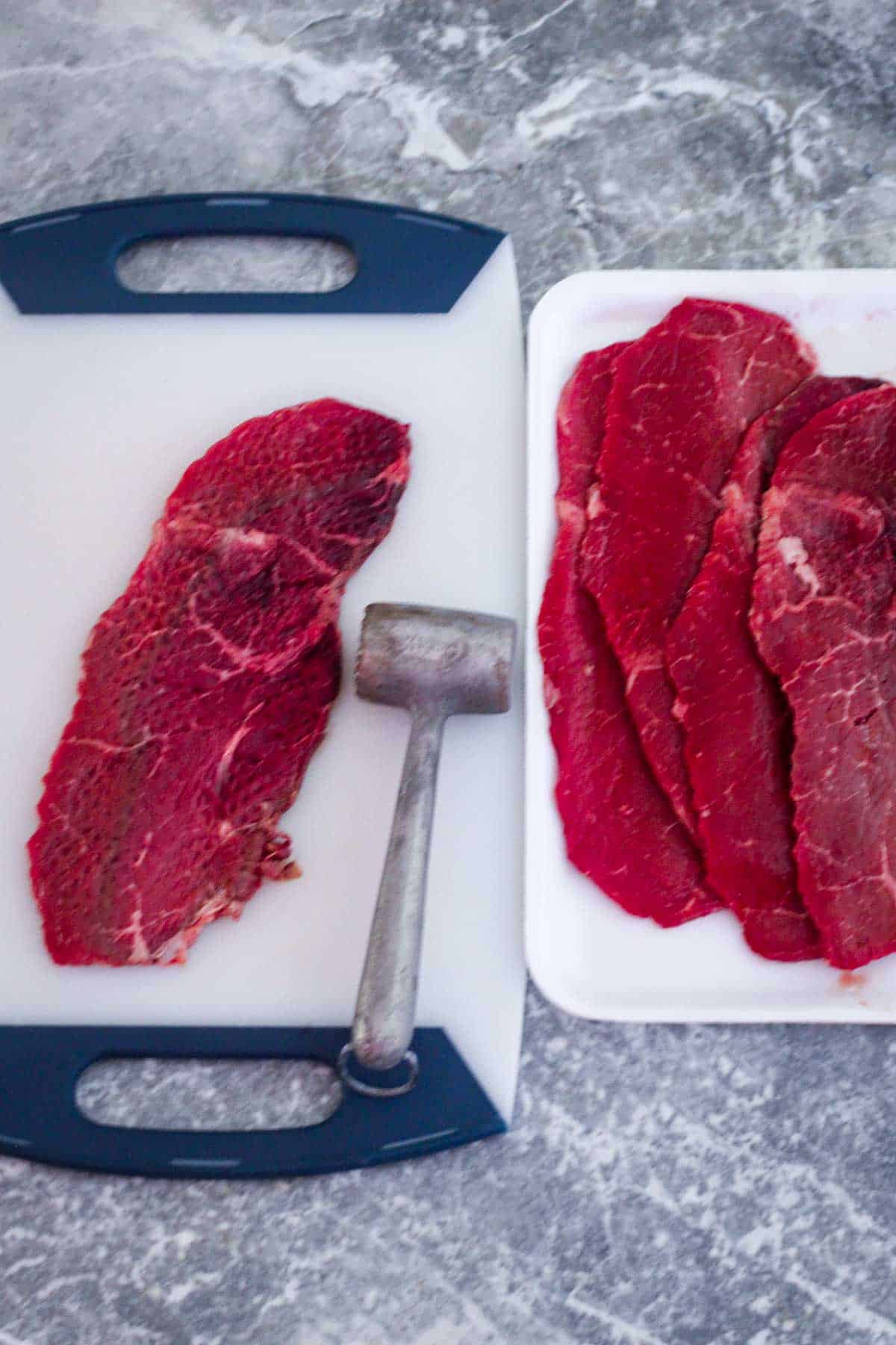 Tenderizing thin steaks to make beef milanesa steaks.